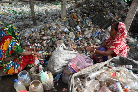 Women in India sorting plastic in a landfill