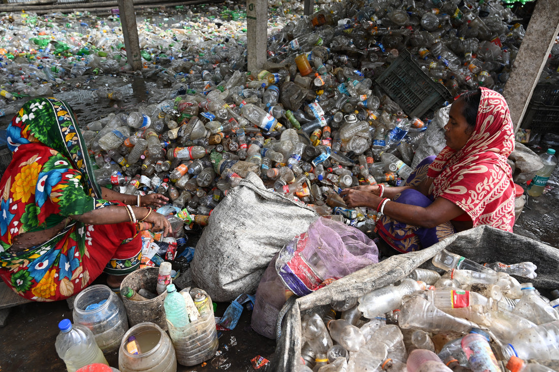 Women in India sorting plastic in a landfill 